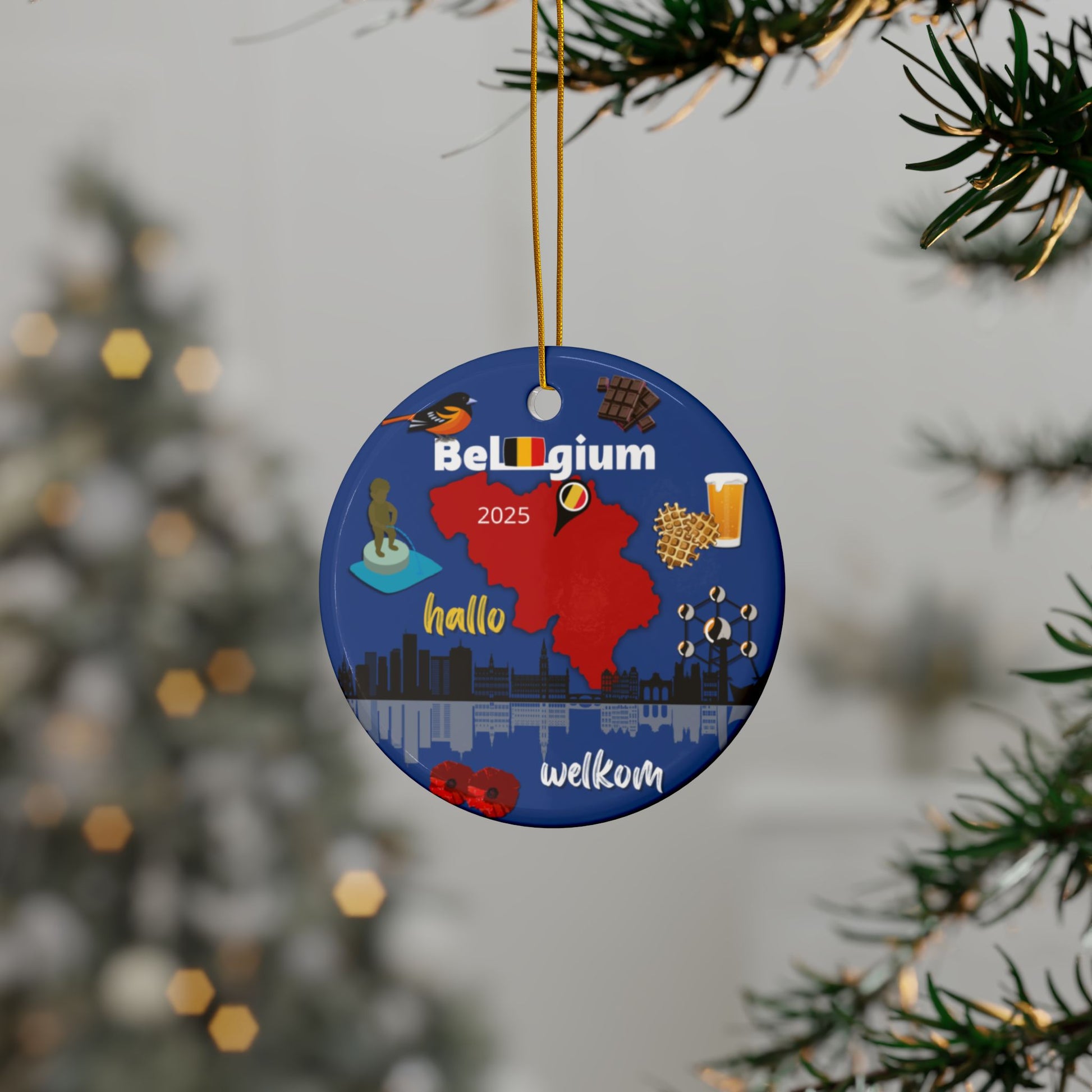 Decorative ornament with Belgium-themed graphics hanging on a tree branch.