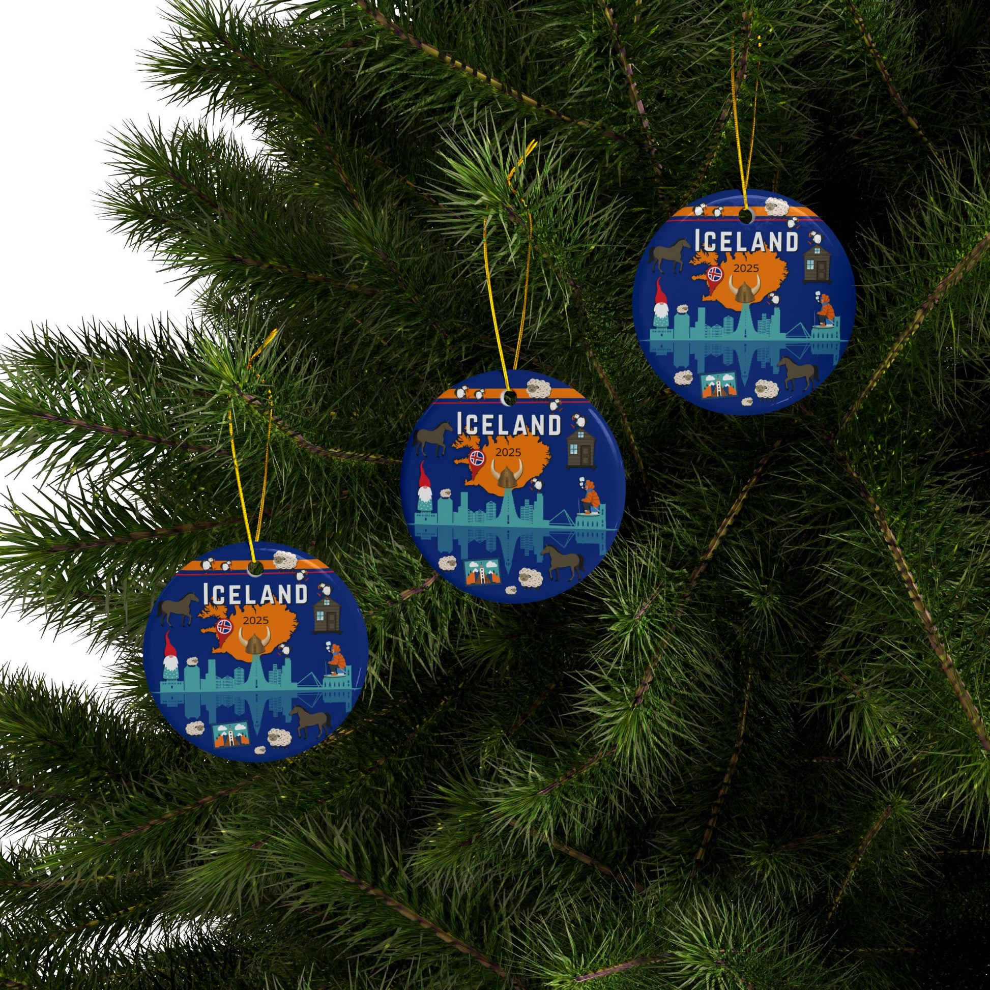 Three blue Iceland-themed Christmas ornaments hanging on a tree.