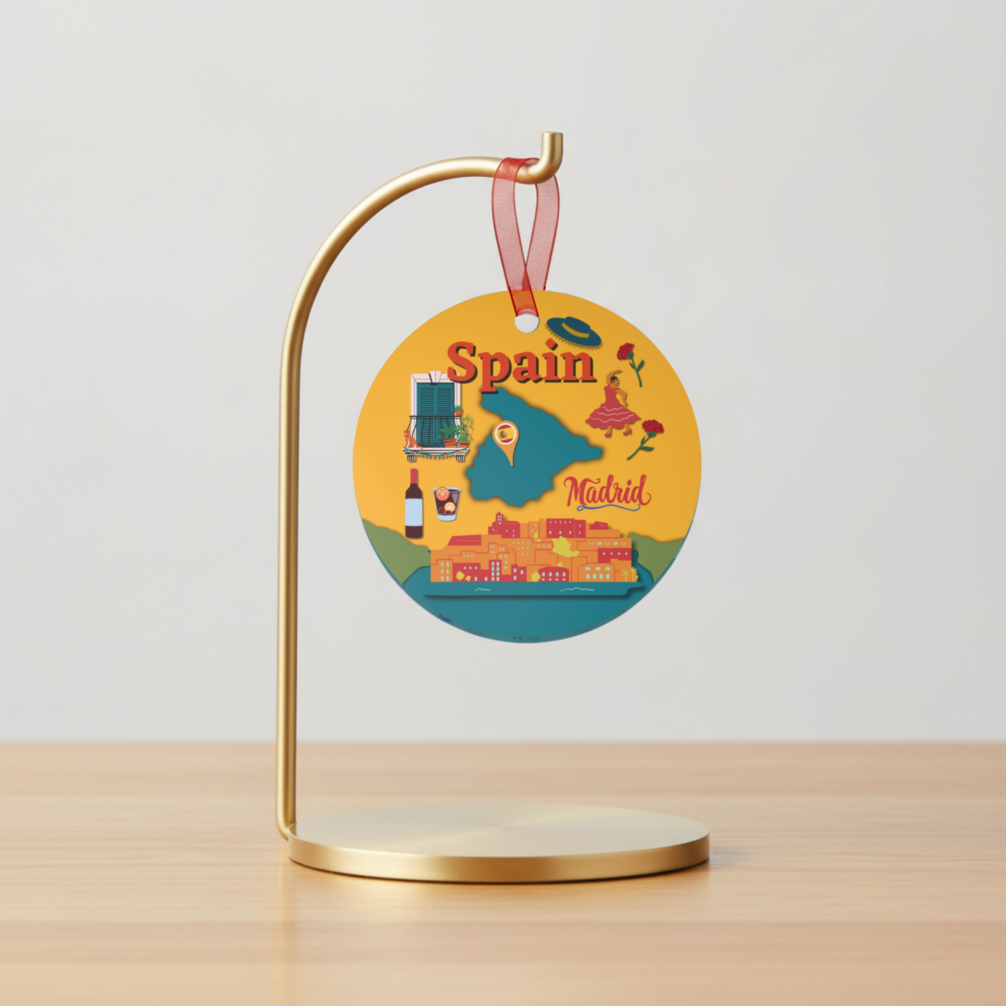 Decorative round sign with 'Spain' and 'Madrid' on a gold stand against a light gray background.