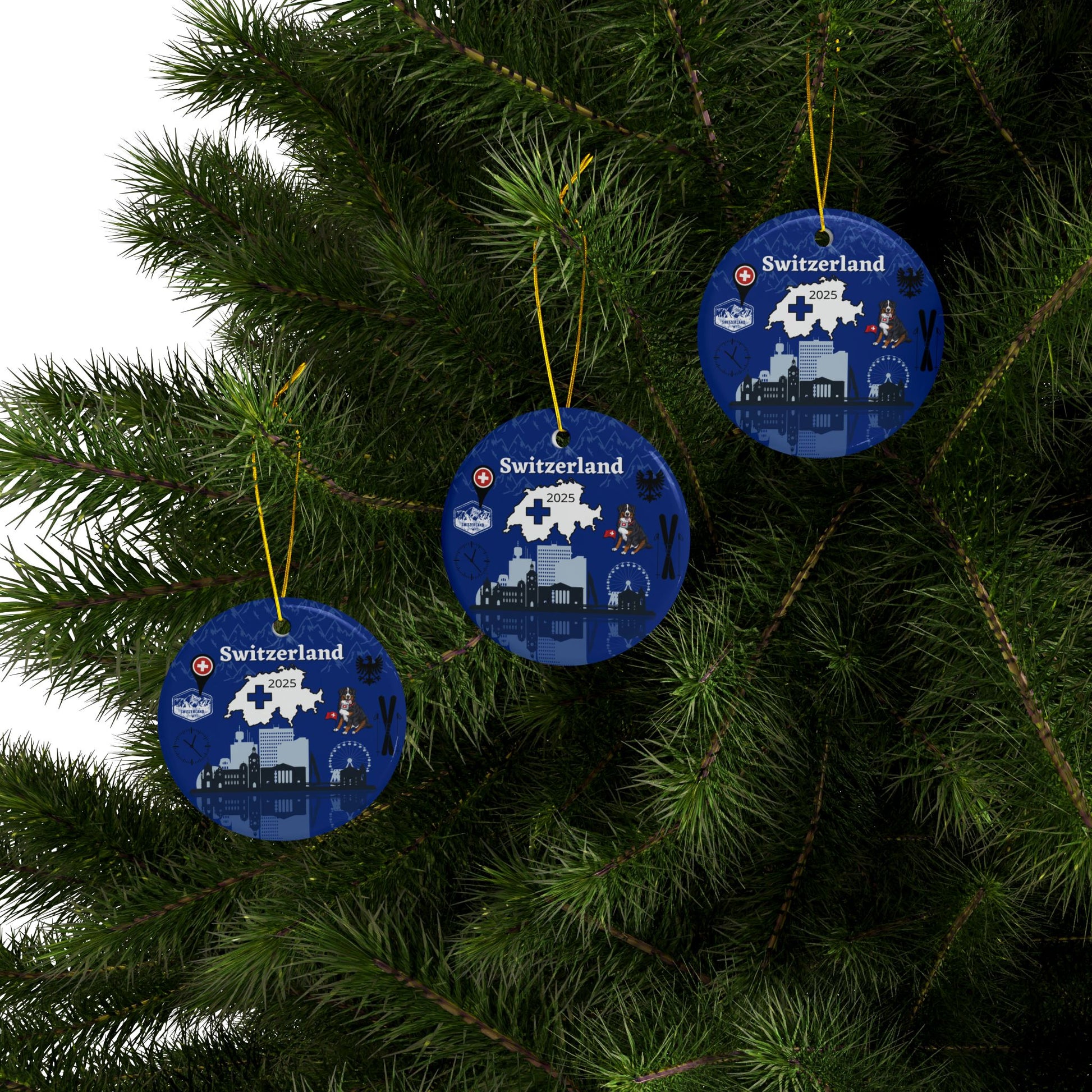 Three blue Christmas ornaments with Switzerland designs hanging on a tree.